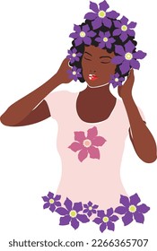 Young woman with dark skin and curly hair wearing t-shirt with clematis flowers illustration.
