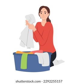 Young woman doing housework chores sorting dirty laundry in clothes basin. Flat vector illustration isolated on white background