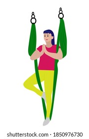 Young woman doing yoga and doing gymnastics with a hammock . Antigravity yoga, the strengthening and straightening of the spine.