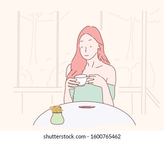 young woman drinking coffee at table in cafe.Eps10 vector.