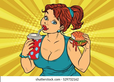 Young woman drinking Cola and eating Burger