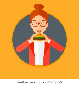 Young woman eating hamburger. Happy woman with eyes closed craving hamburger. Woman is about to eat delicious hamburger. Vector flat design illustration in the circle isolated on background.