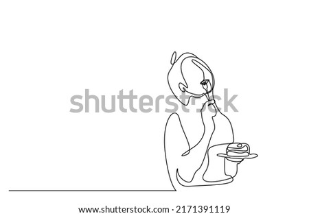 a young woman eats a slice of cake with a fork and is happy with the taste