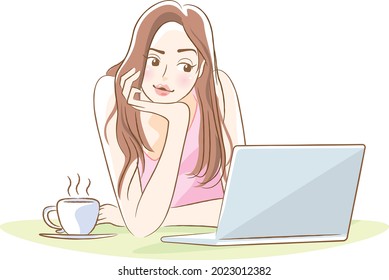 Young woman with elbows looking at a laptop (coffee break)