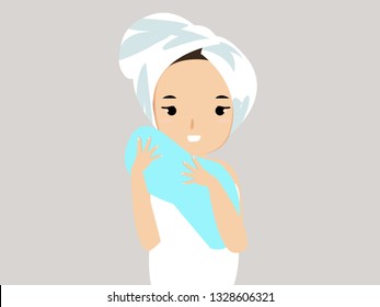 young woman face with white towel on her head wiping  with a towel after take a shower. 