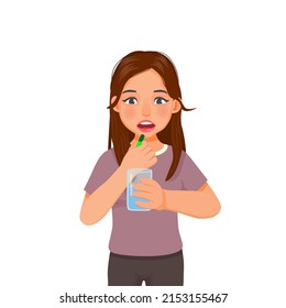 Young woman feeling sick taking medicine capsule with a glass of water
