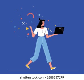 Young woman freelancer walks and holds a laptop in her hands. Concept of remote work, training, online shopping