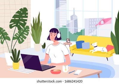 Young woman freelancer works remotely from her apartment. The concept of distant work during the quarantine and isolation of coronavirus