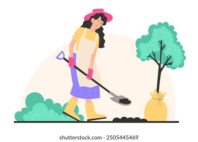 A young woman in garden clothes digs the ground with a shovel and plants a young tree