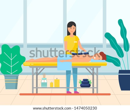 Young woman getting hot stone massage. Girl enjoying traditional body care procedure in spa salon. Professional masseuse and female patient vector. Modern office with big windows