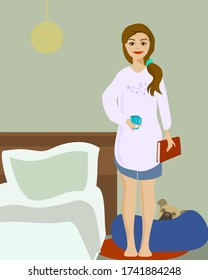 Young Woman Getting Ready For Bed With A Book And A Cup Of Tea, With Her French Bulldog 