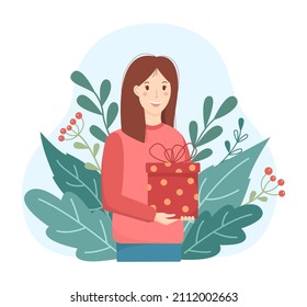 Young woman gift concept in flat style. A happy girl standing and holding a gift in her hands. Natural background of green leaves. Cute vector illustration.