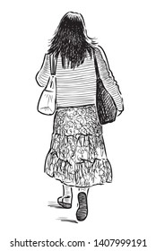 A young woman goes with the bags down the street