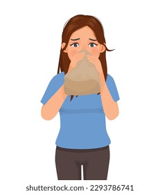 Young woman having panic attack breathing into paper bag 
