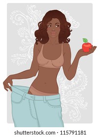 Young Woman in her old jeans after losing weight holding red apple