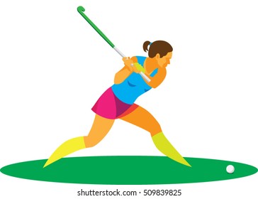 Young woman is hockey players on the grass strikes the ball