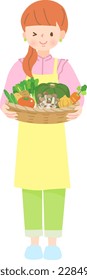 Young woman holding a basket of vegetables