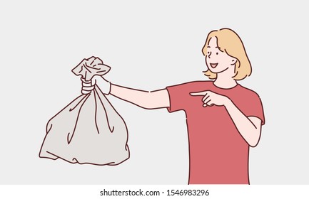 Young woman holding a garbage bag and pointing isolated on white background. Hand drawn style vector design illustrations.