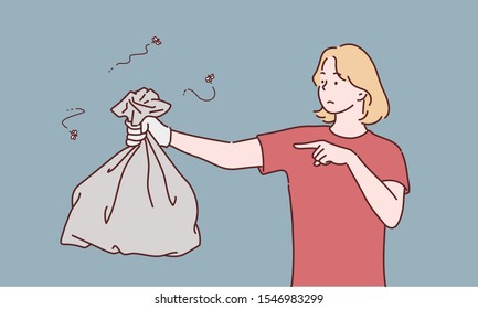 Young woman holding a garbage bag and pointing isolated on gray background. Hand drawn style vector design illustrations.