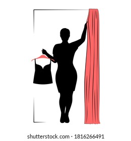Young woman is holding hanger with clothes in one hand and pulling curtain of fitting room with another hand. Dark silhouette of lady of plus size. Modern female shopping, fashion concept