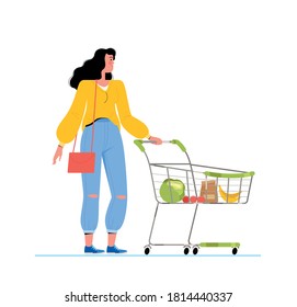Young woman holds a cart with groceries in the store. Supermarket shopping concept