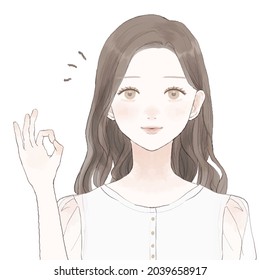 Young woman ing ok sign.　She is making an OK sign with one hand.