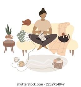 Young woman knits while sitting at home on sofa in a cozy interior,comfortable environment with two cats Vector illustration in flat style.Hobbies and work, manual labor. Warm things connected by hand