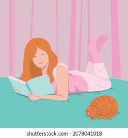 Young woman llies on bed and reads book