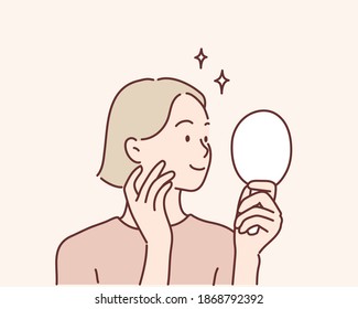 Young woman looking at mirror at home. Hand drawn style vector design illustrations.