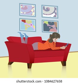 Young woman lying relaxed on couch with phone and listening to music