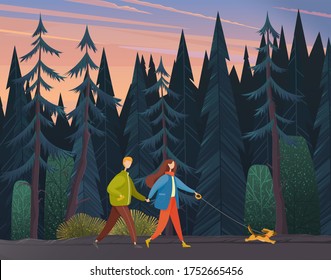 Young woman and man holding each other's hand, walking together outdoor with small dog along the forest road in the evening. Romantic pastime concept, family weekend and walks with pet in autumn park