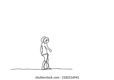 a young woman outside walking thoughtfully looking at the ground