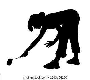 Young woman painting floor with paint roller 