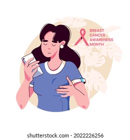 Young woman palpates her breasts, looking at the phone - breast cancer self-diagnosis. Breast Cancer Awareness Month.
