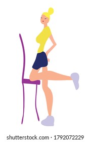 Young woman performs an exercise using a chair. Sports activities. Workout. Stretching