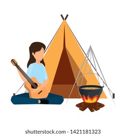 young woman playing guitar with camping tent and campfire