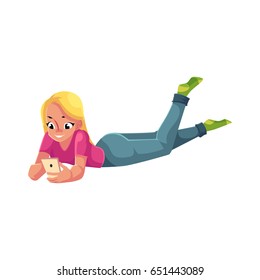 Young woman playing with smartphone, using mobile phone, lying on her stomach, cartoon vector illustration isolated on white background. Woman, girl in jeans and t-shirt lying with mobile phone