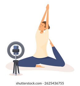 Young woman practicing yoga, recording online course at home using smartphone on tripod and ring lamp