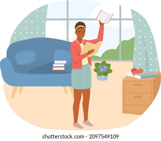 Young woman reading book standing near stack of books in living room, studying at home. Housewife resting with book, female character is fond of literature, enjoys reading, gets education