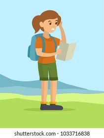 Young woman reading the map finding direction hiking