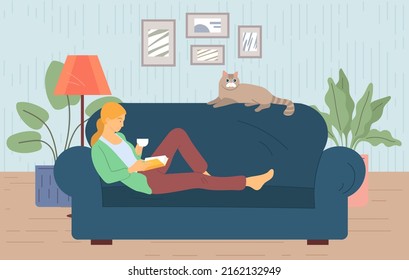 Young woman reads book on couch at cosy home. Girl sitting on sofa with her cat, reading book and resting. Female daily lifestyle in living room. Character in modern room, studend reads literature