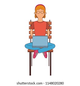 Young woman seated on chair using laptop faceless