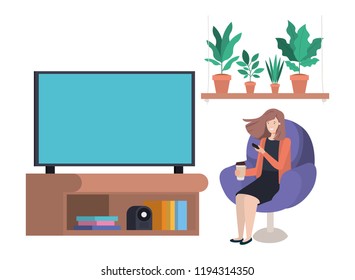 young woman seated in the sofa watching tv