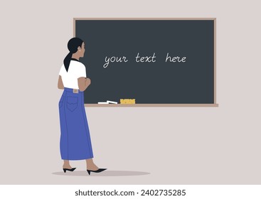 A young woman seen from behind writing on a classroom chalkboard