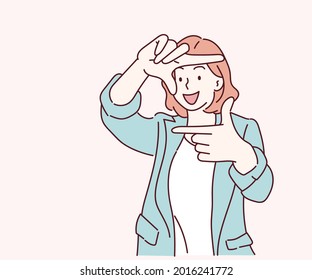 Young woman shows a frame from hands like take photography with happy face. Creativity and photography concept. Hand drawn in thin line style, vector illustrations.