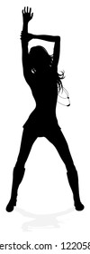 A young woman in silhouette dancing like at a night club or other event
