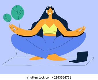 A young woman sits cross-legged on the floor and meditates with her eyes closed. The girl is doing morning yoga, relaxing at home or doing breathing exercises. Mental health