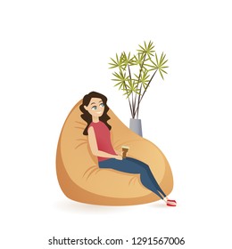 Young Woman Sitting Calm in Brown Beanbag Chair. Smiling Freelance Female Character Holding Cup of Tea or Coffee Having Break, Resting at Coworking Space. Flat Cartoon Vector Illustration