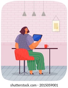 Young woman sitting in comfortable armchair with tablet. Freelancer, remote work. Home office. Student studies online. Business woman at desk working on laptop computer. Secretary in office workspace
