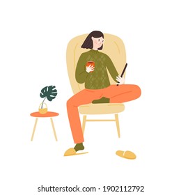 Young Woman Sitting In Comfortable Chair, Holding And Reading Tablet While Drinking Coffee. Stay At Home Illustration Concept. Girl In Glasses Wearing A Green Sweater And Red Sweat Pants. Cozy Vector Illustration